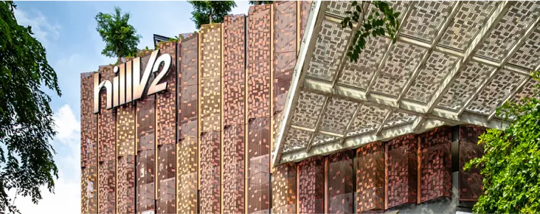 HillV2 Shopping Mall - The exterior facade of nearby HillV2 shopping mall, featuring a unique design with a mix of metallic and greenery elements.